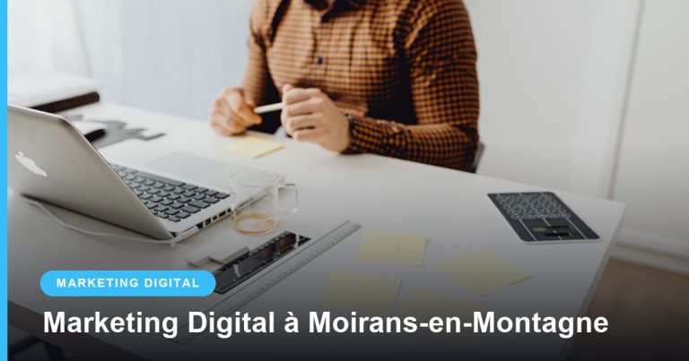 Entrepreneur prenant des notes à côté d’un ordinateur portable sur un bureau clair