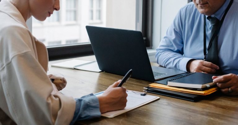 Chef d'entreprise et community manager en rendez-vous autour d'un ordinateur portable